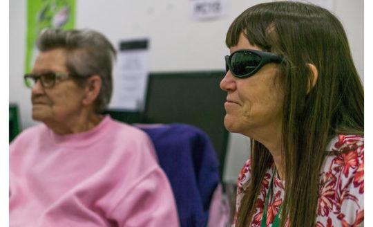 Two ladies in a visually impaired reading group meeting